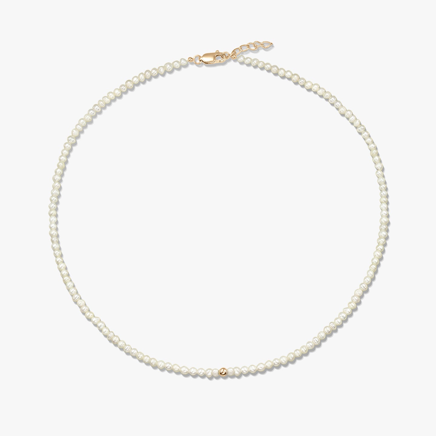 Square product image of a delicate natural pearl beaded necklace with a small 14K yellow gold bead accent and a yellow-gold lobster clasp with short extender, on a white background.