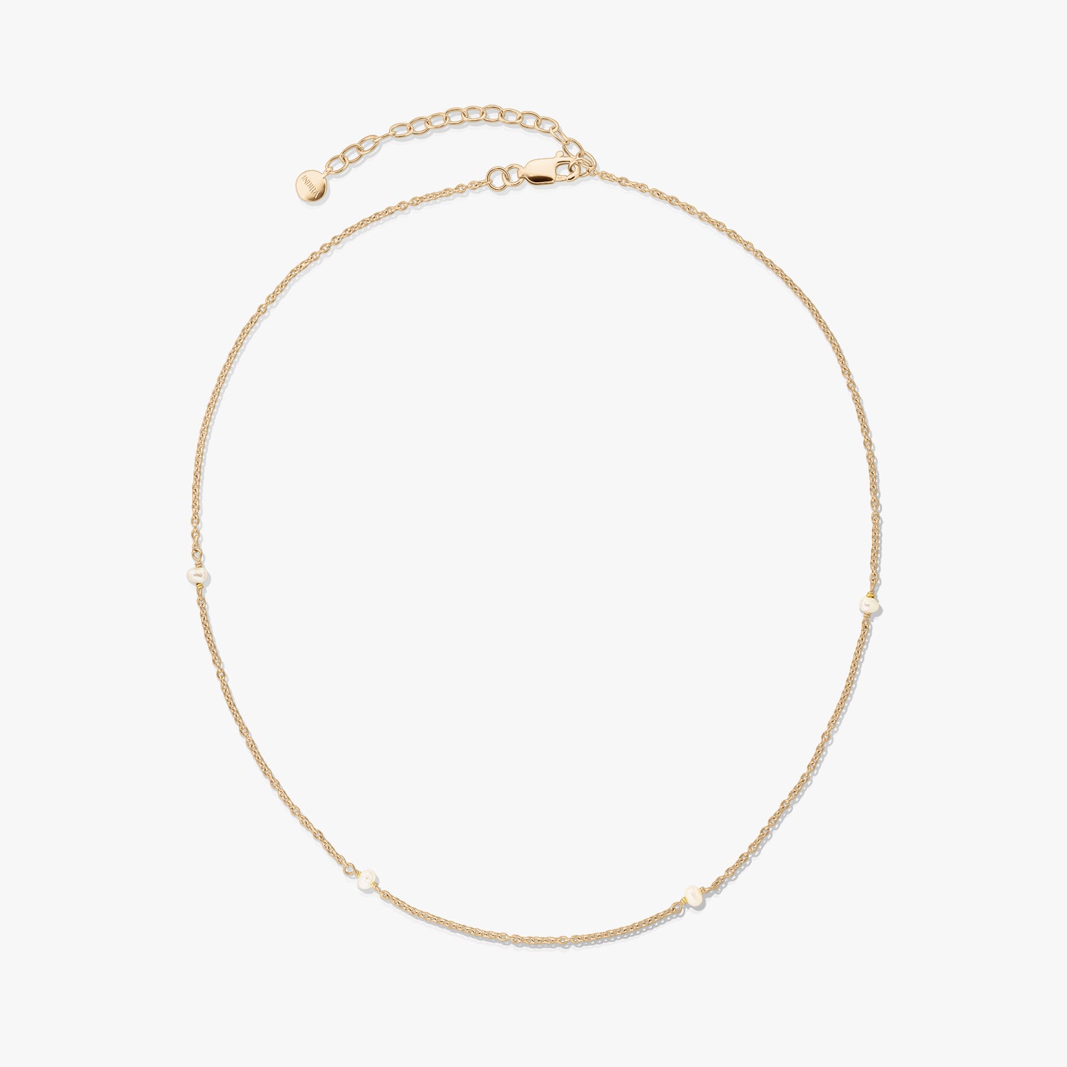 Delicate gold‑plated 925 silver necklace with tiny natural pearls and an adjustable extender with lobster clasp on a white background.