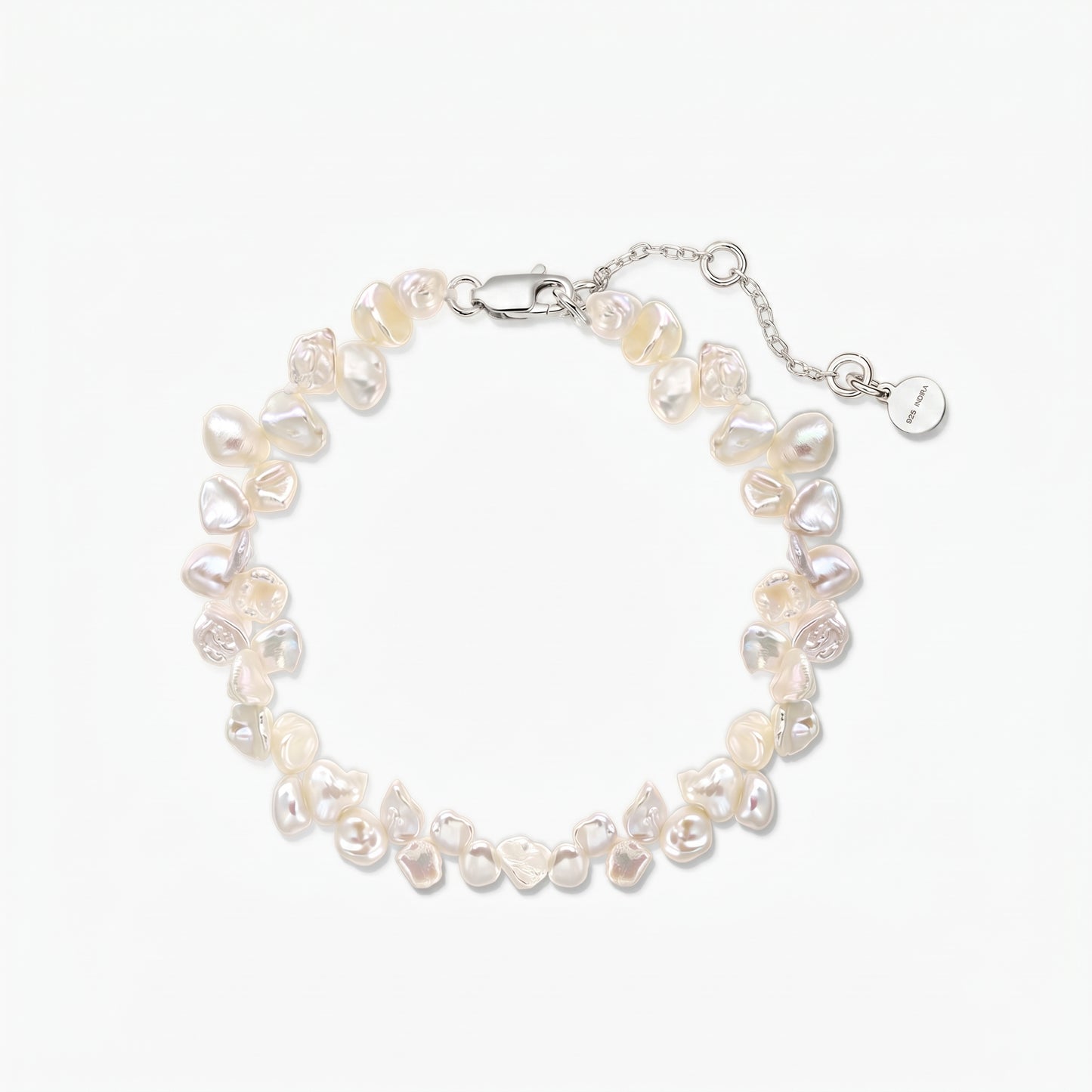 Adjustable keshi freshwater pearl bracelet with a rhodium‑plated 925 silver lobster clasp and extender chain on a white background.