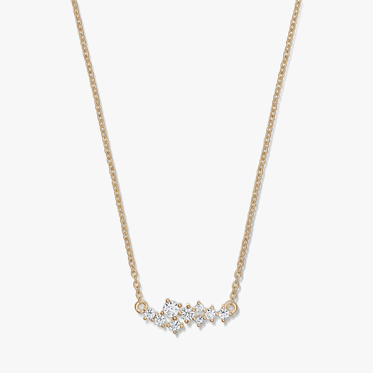 Golden Constellation silver necklace with a delicate chain and a starry cluster of clear stones, photographed on a white background.