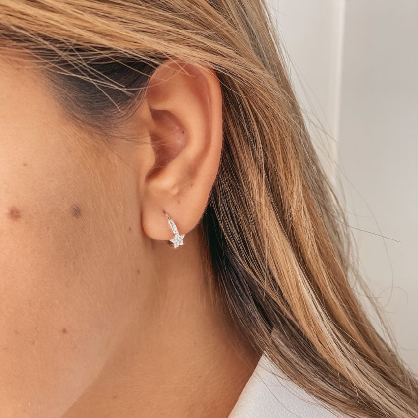 Close-up image of an ear wearing Estella Silver Earrings with Zirconia