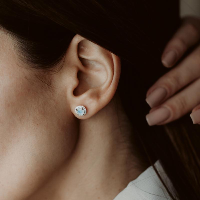 Close-up of an ear wearing a Keira Silver Earring with Moonstone.