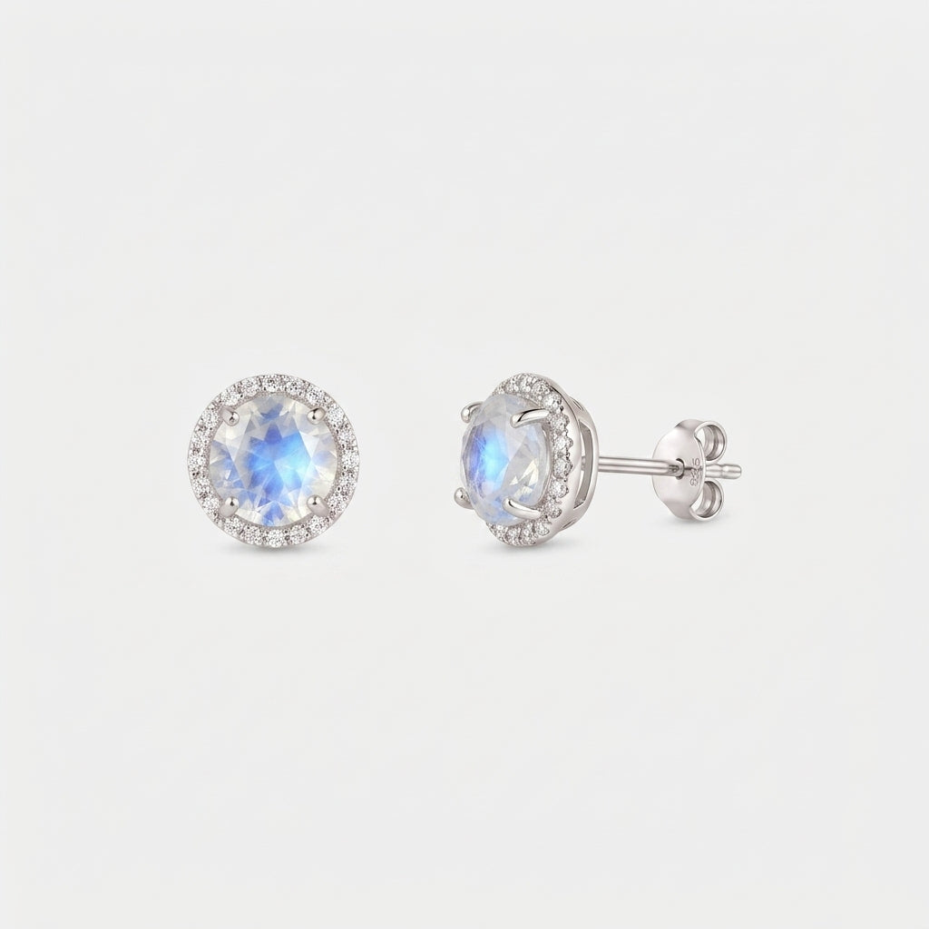 Pair of Keira 925 sterling silver moonstone halo stud earrings, one front view and one side view with butterfly back, on a white background.