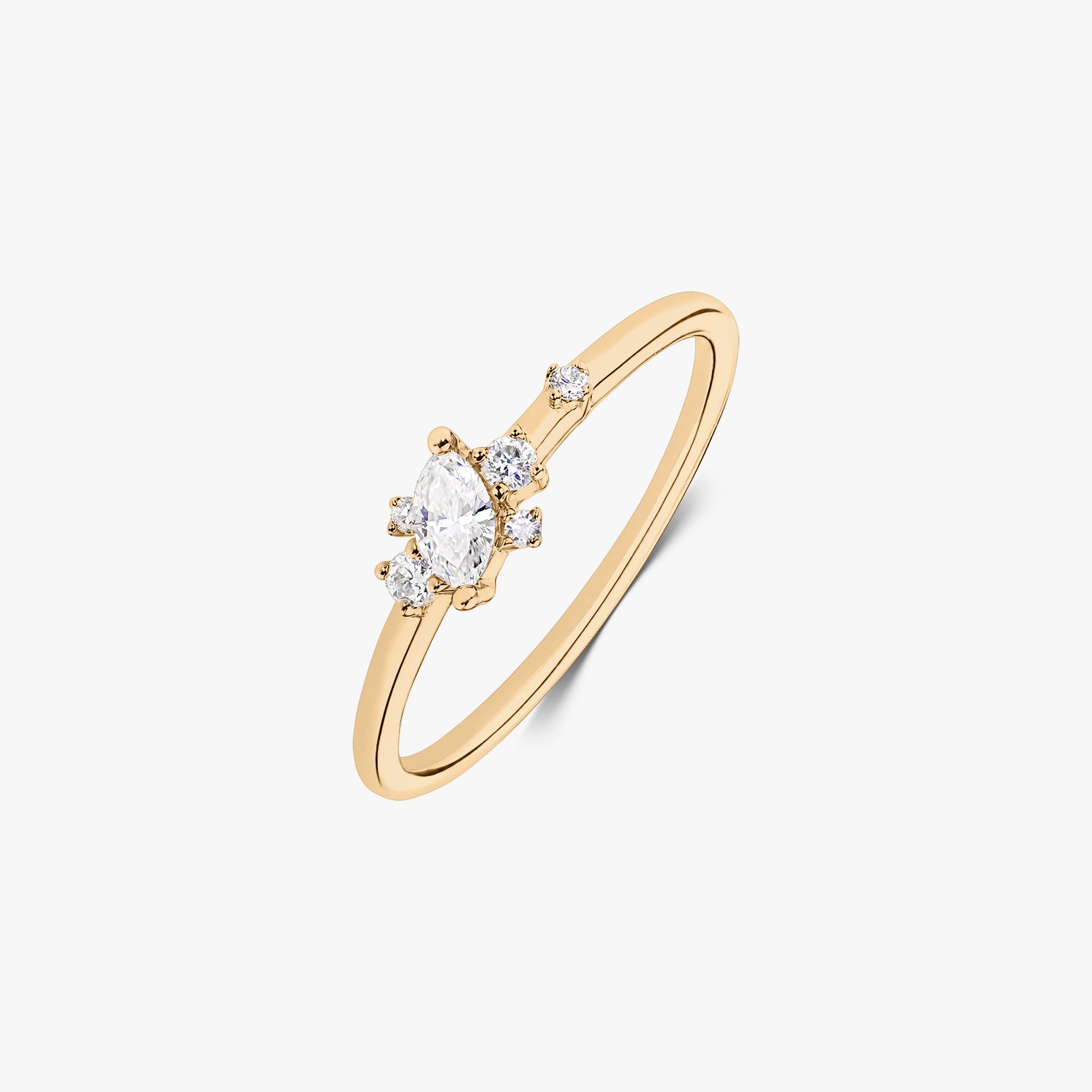 14k yellow gold ring with a marquise-cut center diamond and small round accent diamonds on a slim band, isolated on white.