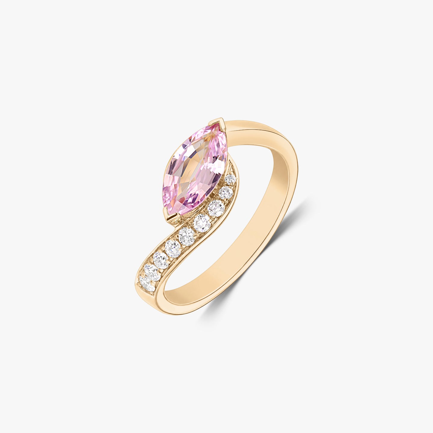 14K yellow gold bypass ring with a marquise‑cut pink sapphire and a row of natural diamonds, isolated on a white background.