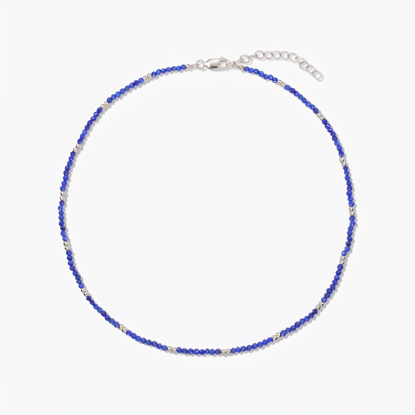 Indira SummerScape silver necklace with blue lapis lazuli beads, lobster clasp, and extender chain on a white background.