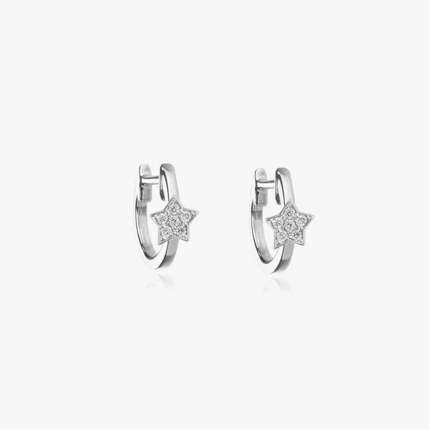 Silver hoop earrings with star-shaped zirconia detailing on a white background.