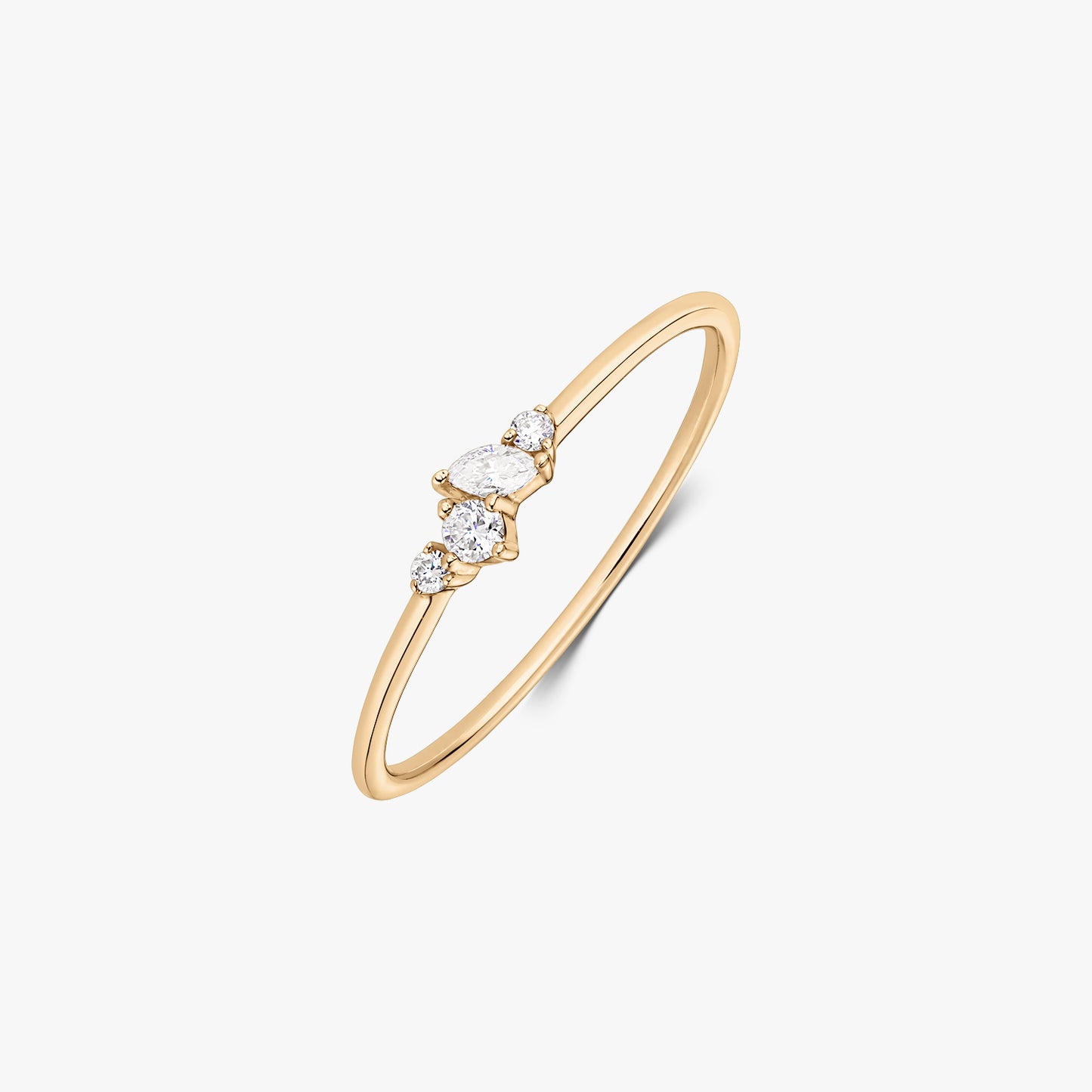 Nova 14K yellow gold ring with a delicate cluster of five white diamonds on a slim band, shown on a white background.