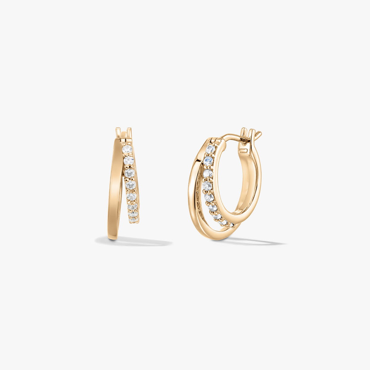 Pair of small gold‑tone double hoop earrings with a row of clear zirconia pavé on a white background, shown from side and angled views.