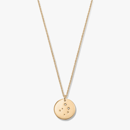 Gold‑tone Libra constellation disc pendant on a fine chain, photographed on a white background.