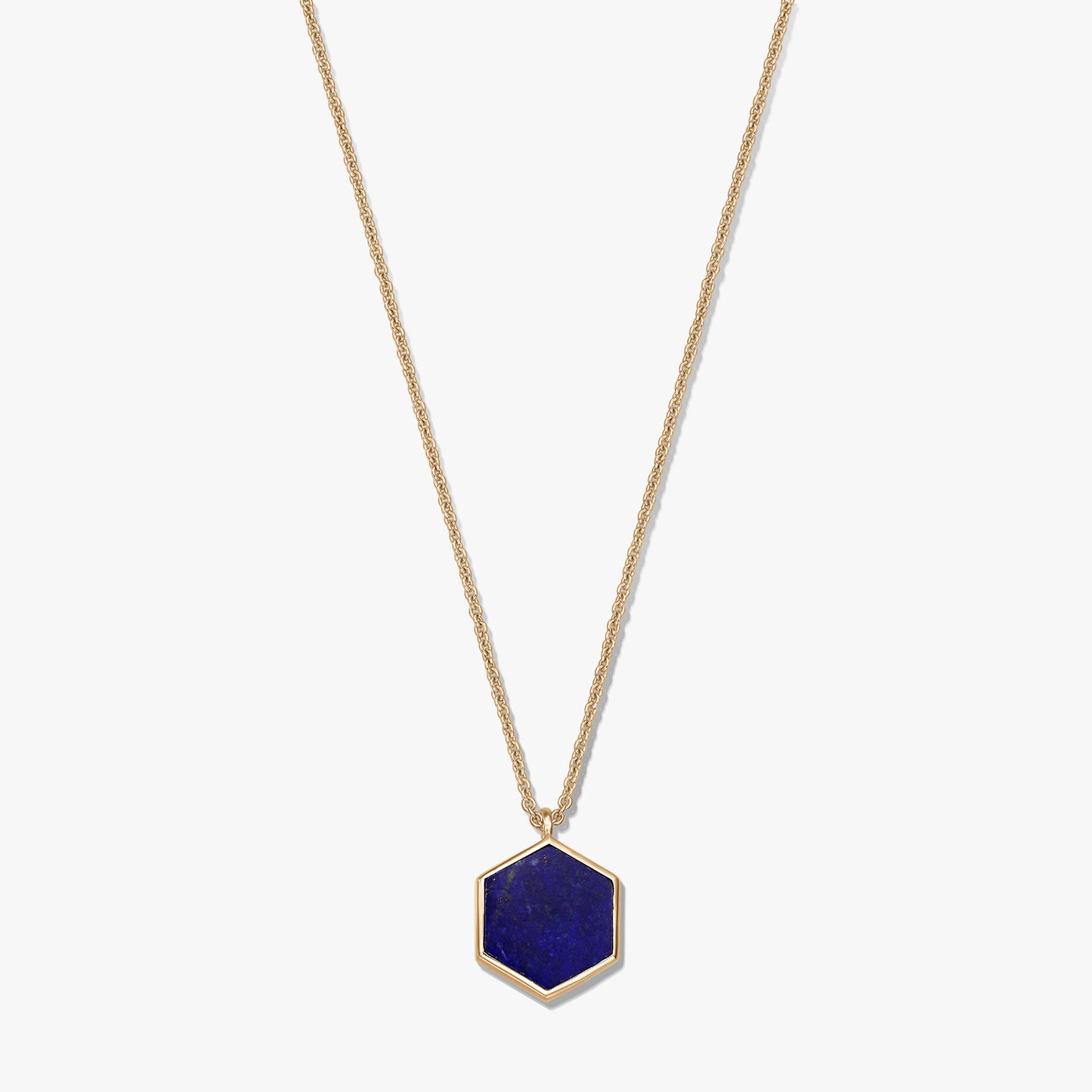 Gold-plated sterling silver necklace with a hexagon lapis lazuli pendant on a white background.
