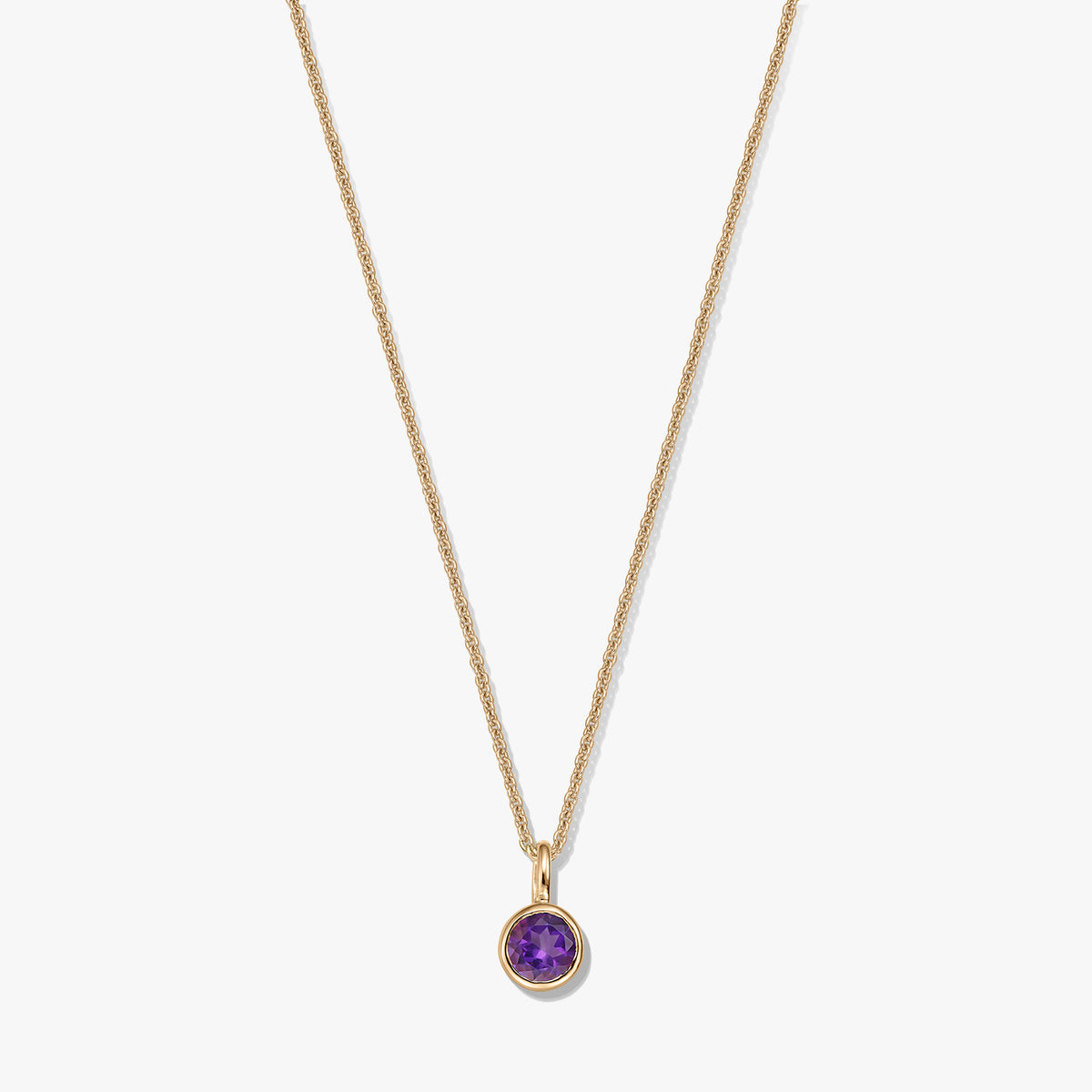 Gold-plated sterling silver necklace with a small round amethyst birthstone pendant on a white background.