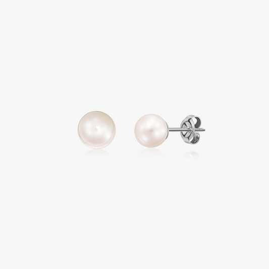 Pair of silver stud earrings with natural pearls on a white background.