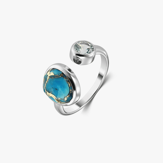 Silver ring with a blue topaz and turquoise gemstone on a white background.