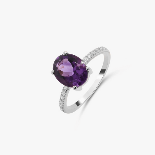 Silver ring featuring a purple amethyst with zirconia accents on a white background.