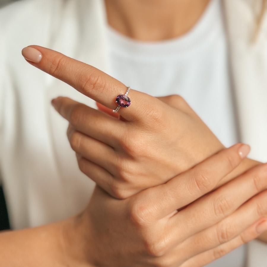 Close-up of a hand wearing a Reina Silver Ring with an Amethyst and Zirconia on the index finger.