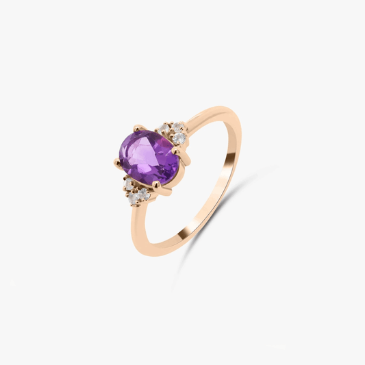 Rose gold ring with amethyst and diamonds on a white background.